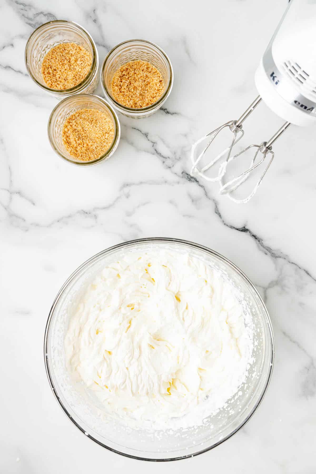Adding sugar to cream cheese for a no-bake cheesecake filling.