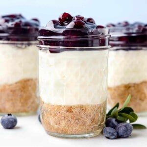 Cheesecake jars topped with blueberry pie filling.
