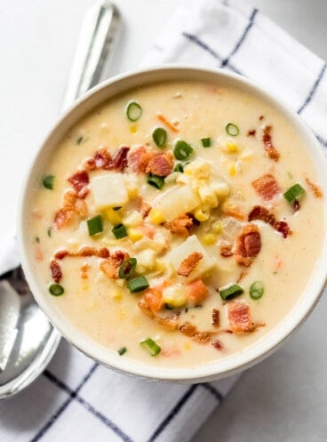 An image of a bowl of Corn Chowder set on a table.