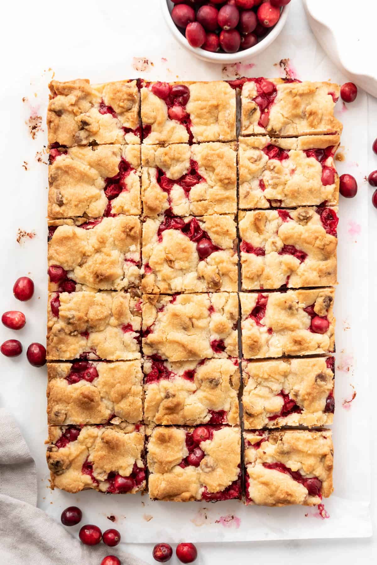 Cutting fresh cranberry bars into squares.