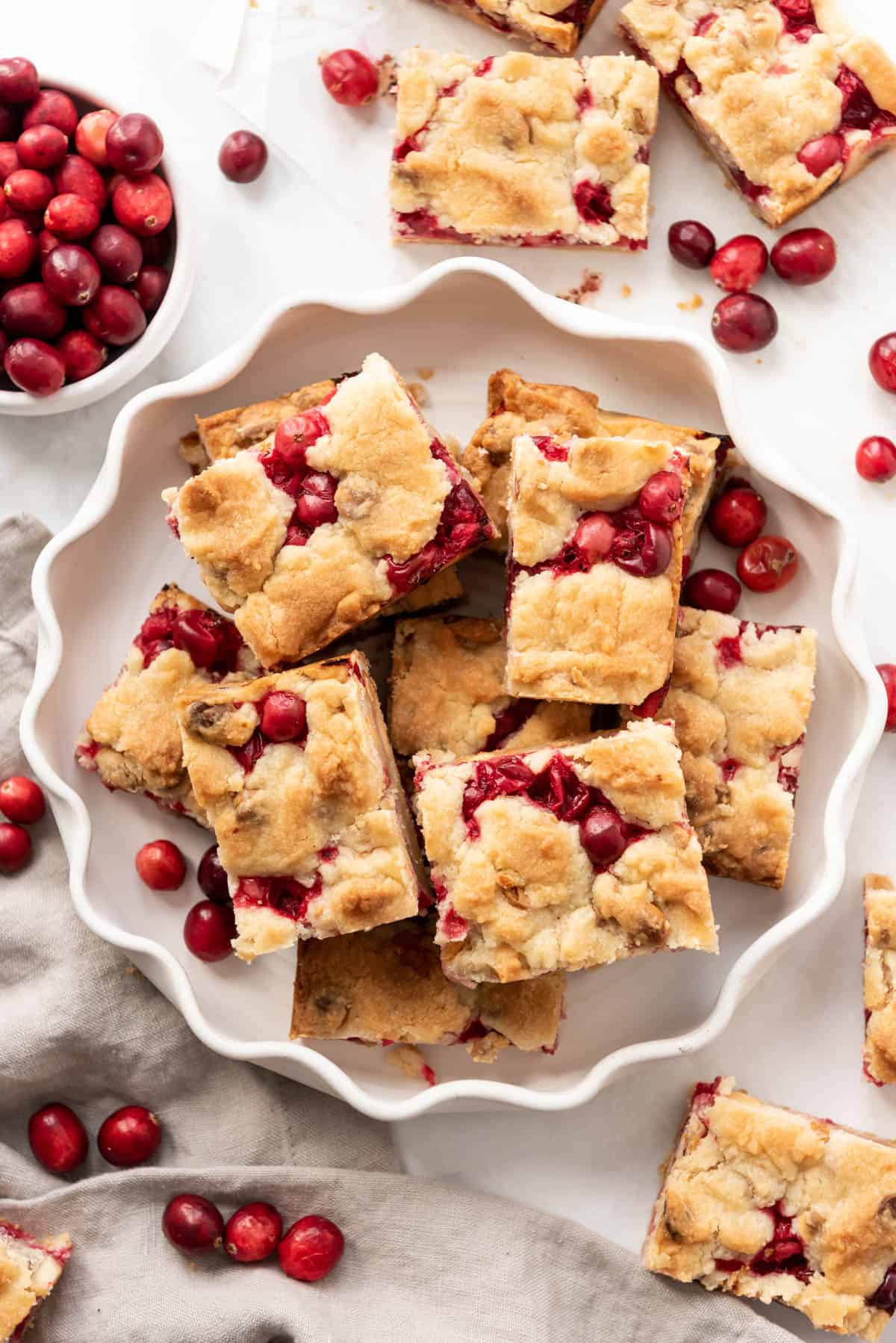 Fresh cranberry shortbread bars on a white plate.