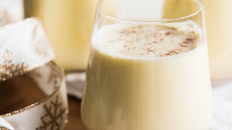 Light, creamy, and spiced with freshly grated nutmeg, this non-alcoholic Old Fashioned Homemade Eggnog is so, SO much better than the store-bought variety that shows up in cartons each year around November or December.  It is both a beloved and beleaguered holiday beverage with a fascinating history.