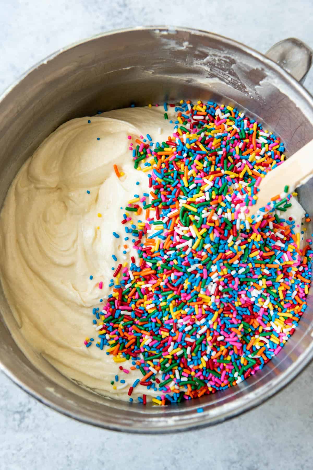 An image of Sprinkles in a mixing bowl with homemade funfetti cake batter about to mixed in.