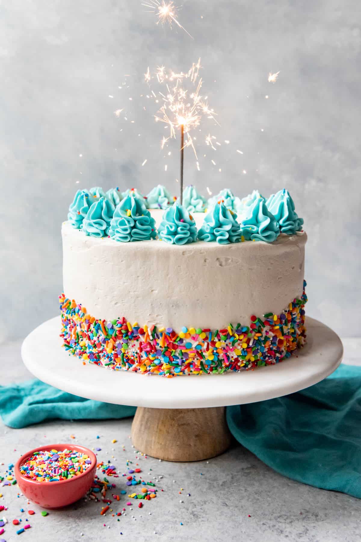 An image of a confetti birthday cake with a sparkler in it.