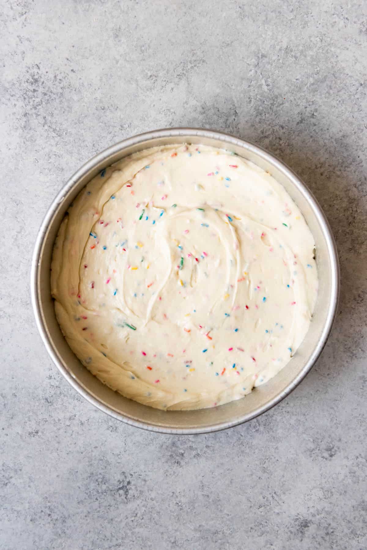 An image of Homemade funfetti cake mix in pan ready to bake.