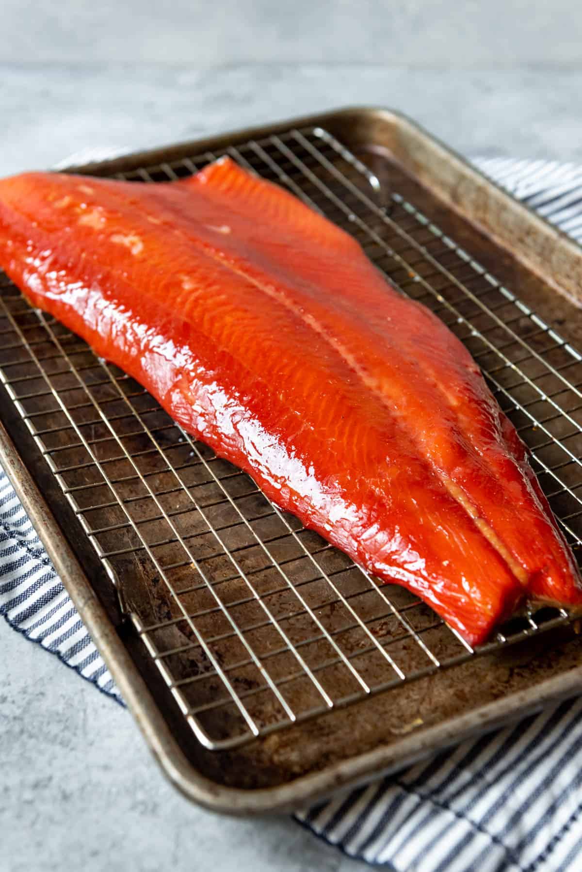 An image of a large whole piece of salmon with the skin-on that has been smoked on a Traeger pellet grill.