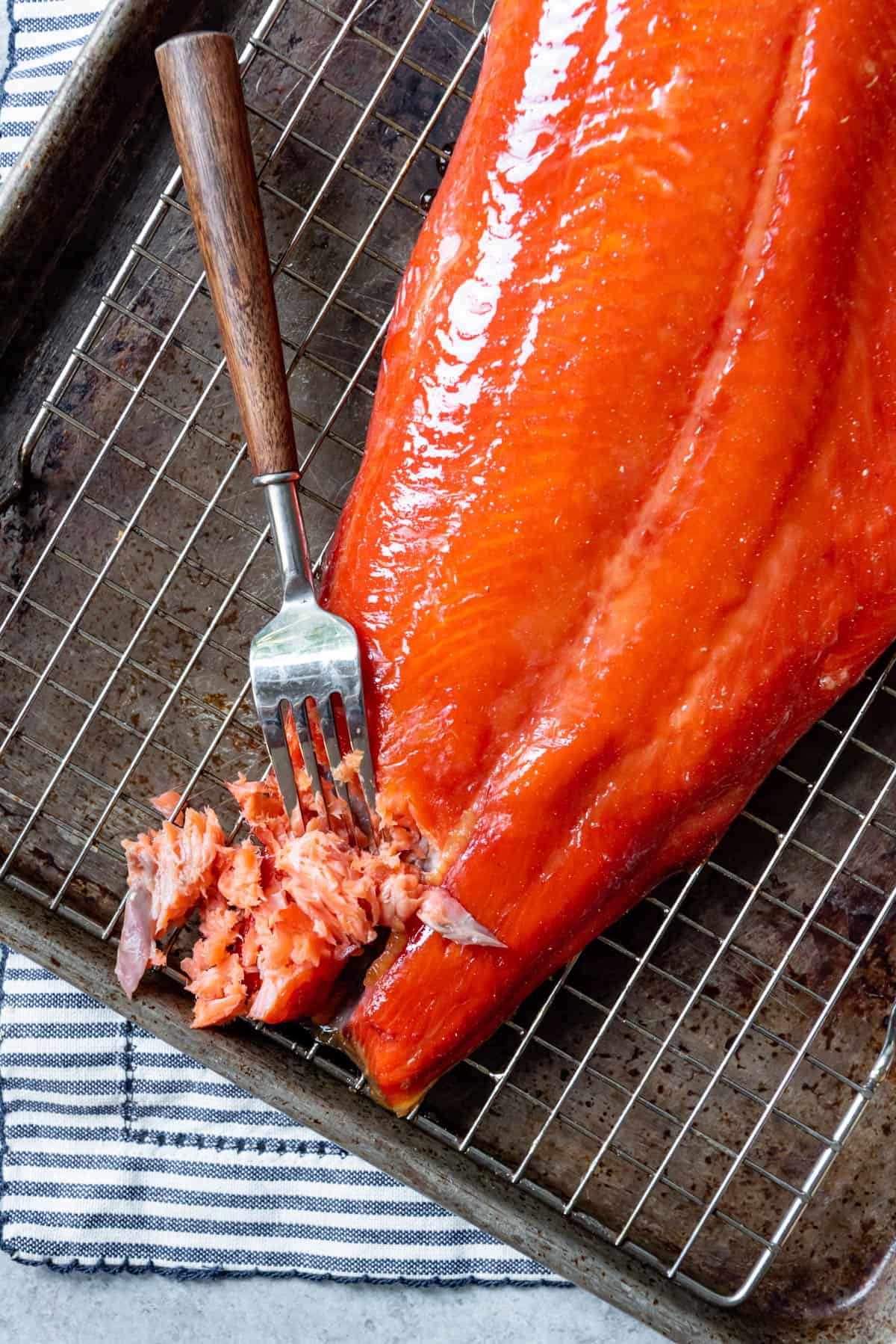 An image of smoked salmon being flaked with a fork.