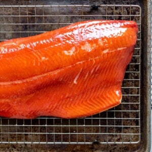 An image of a piece of hot smoked salmon on a wire rack.