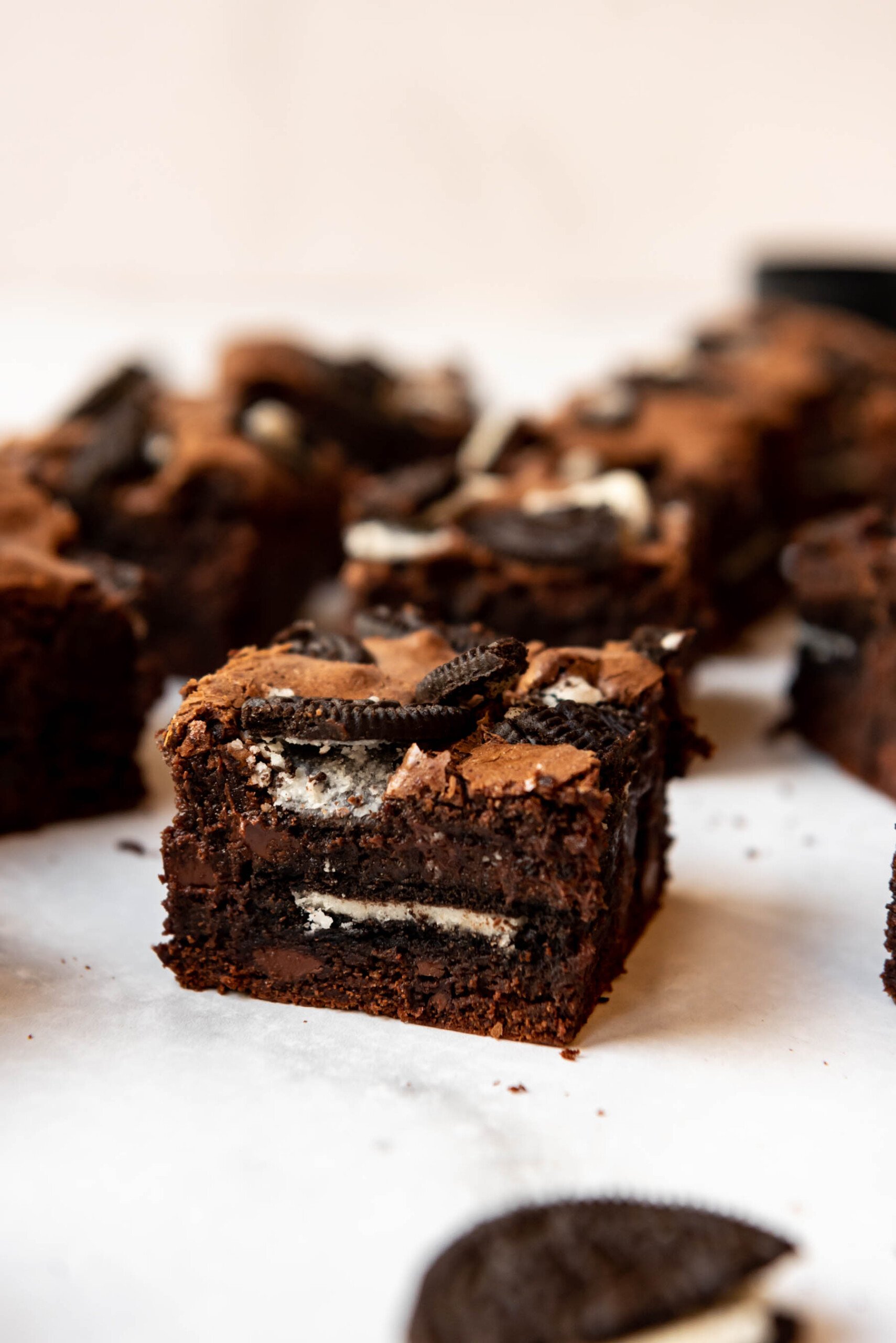 An Oreo brownie with whole Oreos in the middle and crushed Oreos on top.