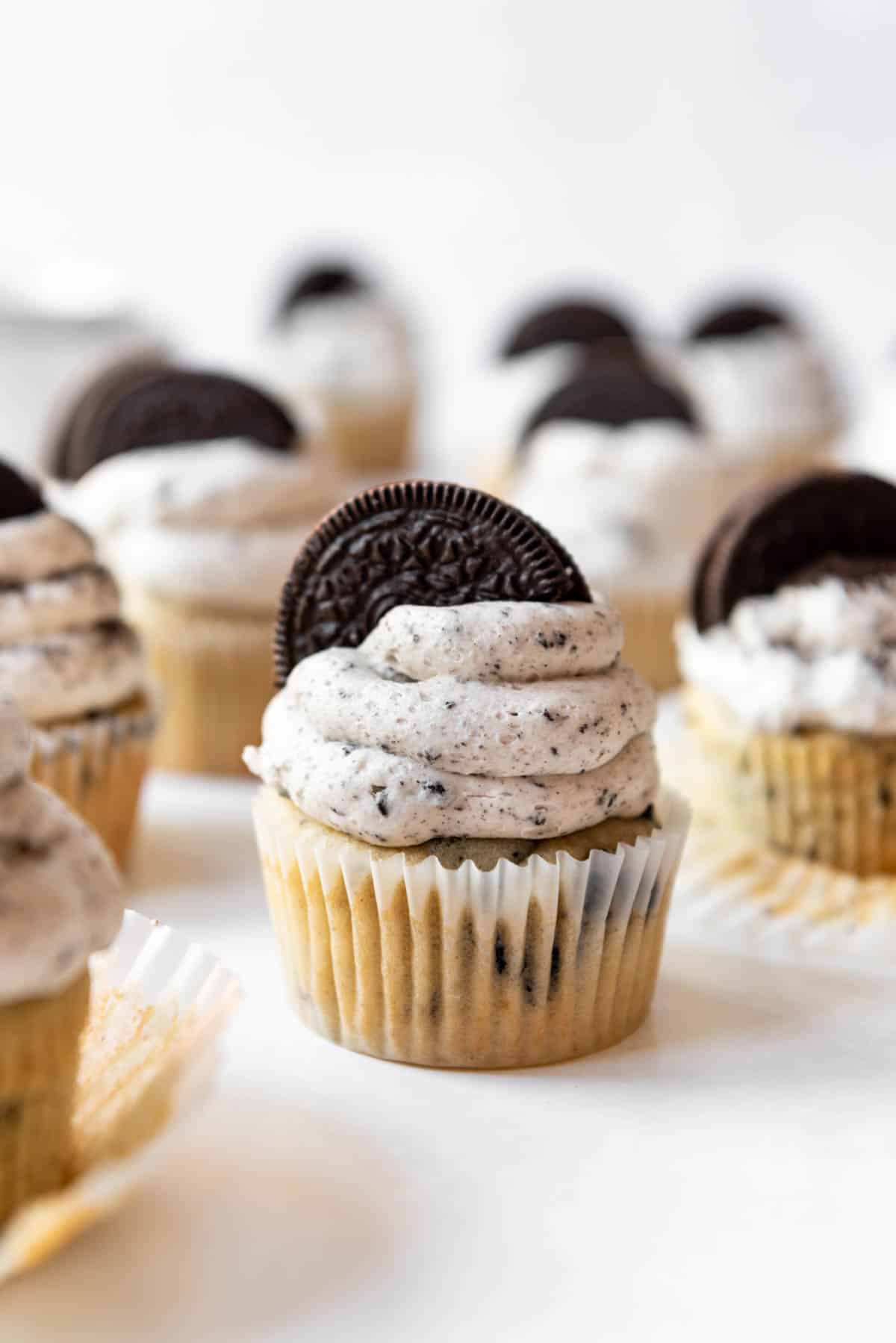 Profile shot of Oreo Cupcakes with Oreo frosting and an Oreo cookie on tip.
