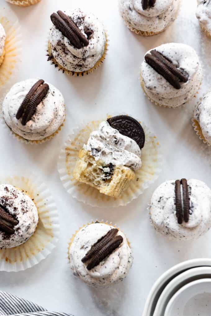 Top view of Oreo cupcakes on a table, the middle one is cut in two.