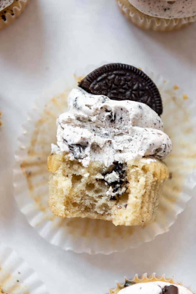 Close up of a Oreo cookie cupcake cut in half, lying down, so you can see a cross section of the cupcake.