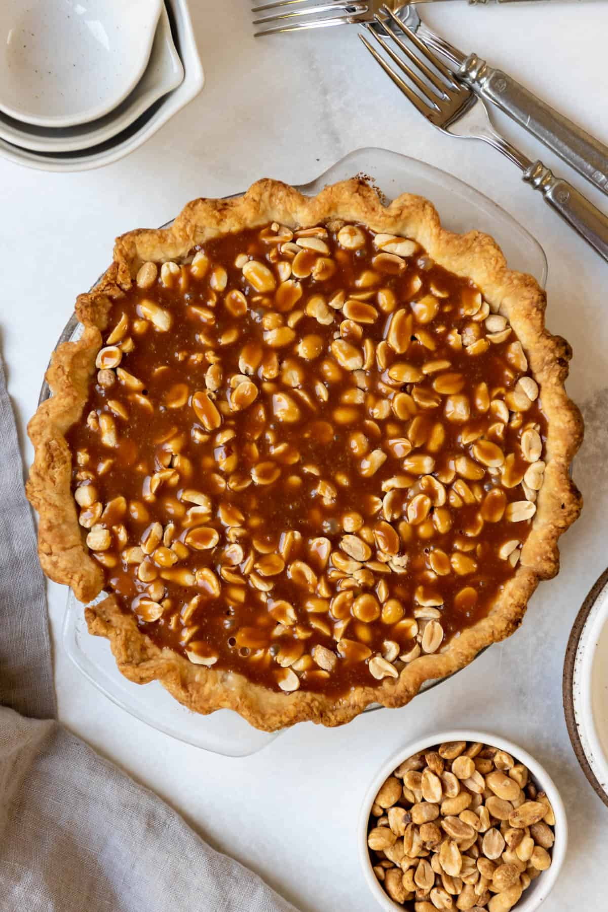 A finished Payday pie with peanuts, nougat, and caramel.