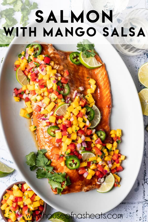 A large salmon filet topped with mango salsa with text overlay.