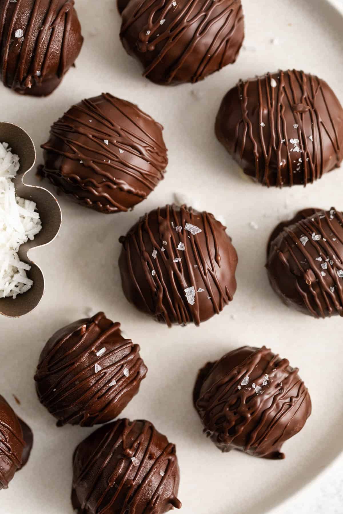 A close image of chocolate covered coconut balls.