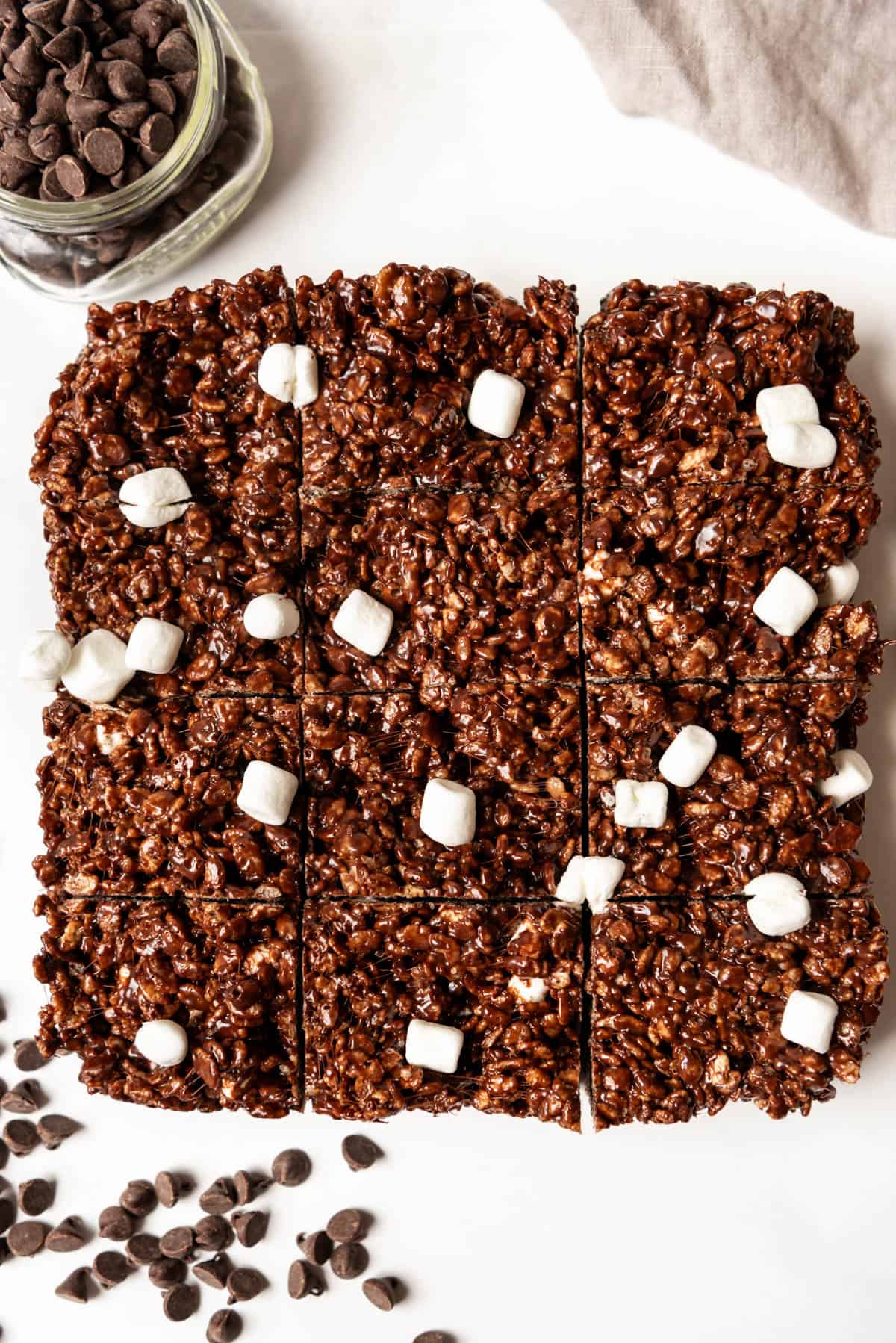 An overhead image of chocolate rice krispies treats cut into squares.