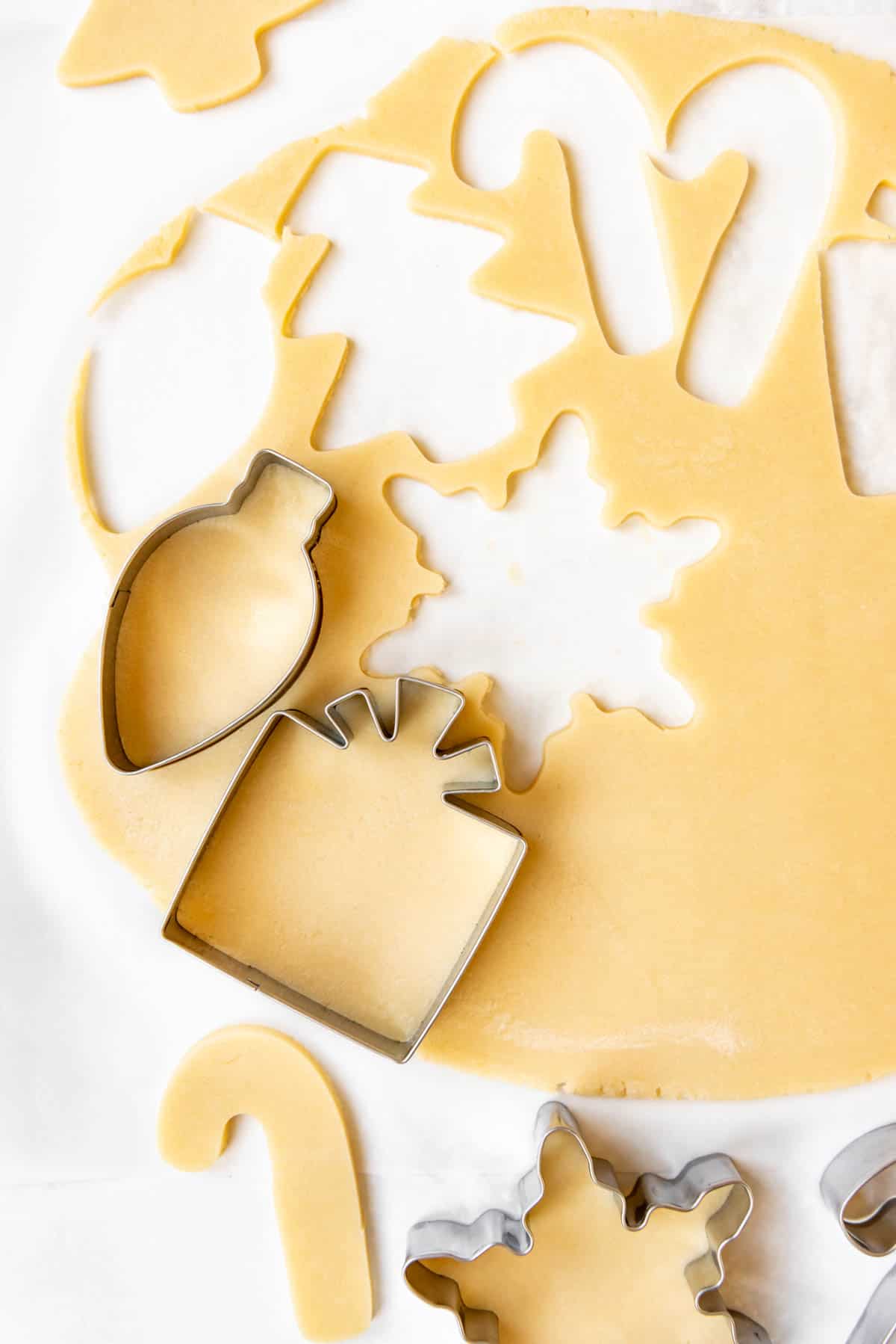 Cutting out sugar cookies with cookie cutters.