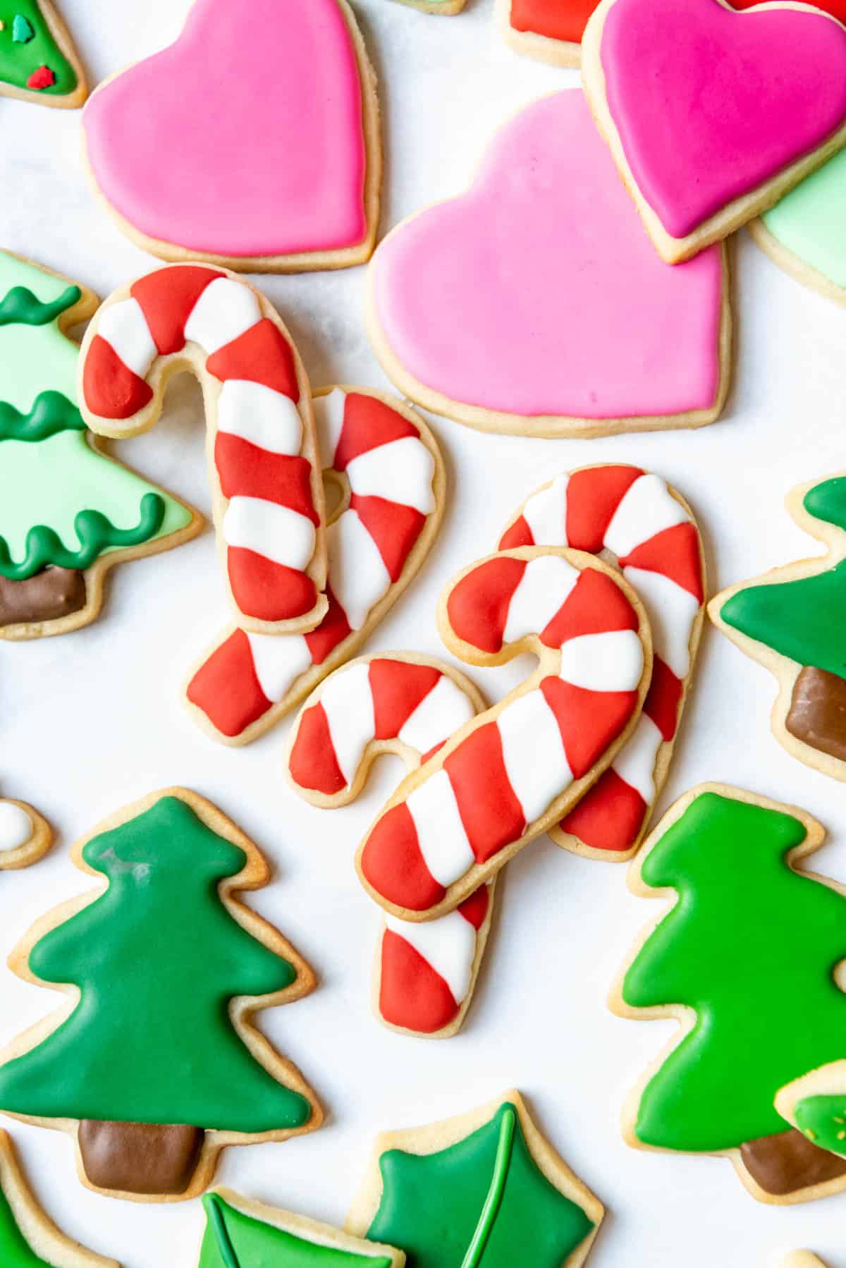 Candy cane striped sugar cookies decorated with royal icing.