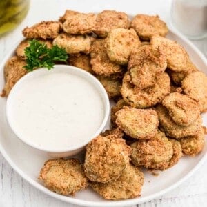 A plate of fried pickles with ranch dressing.