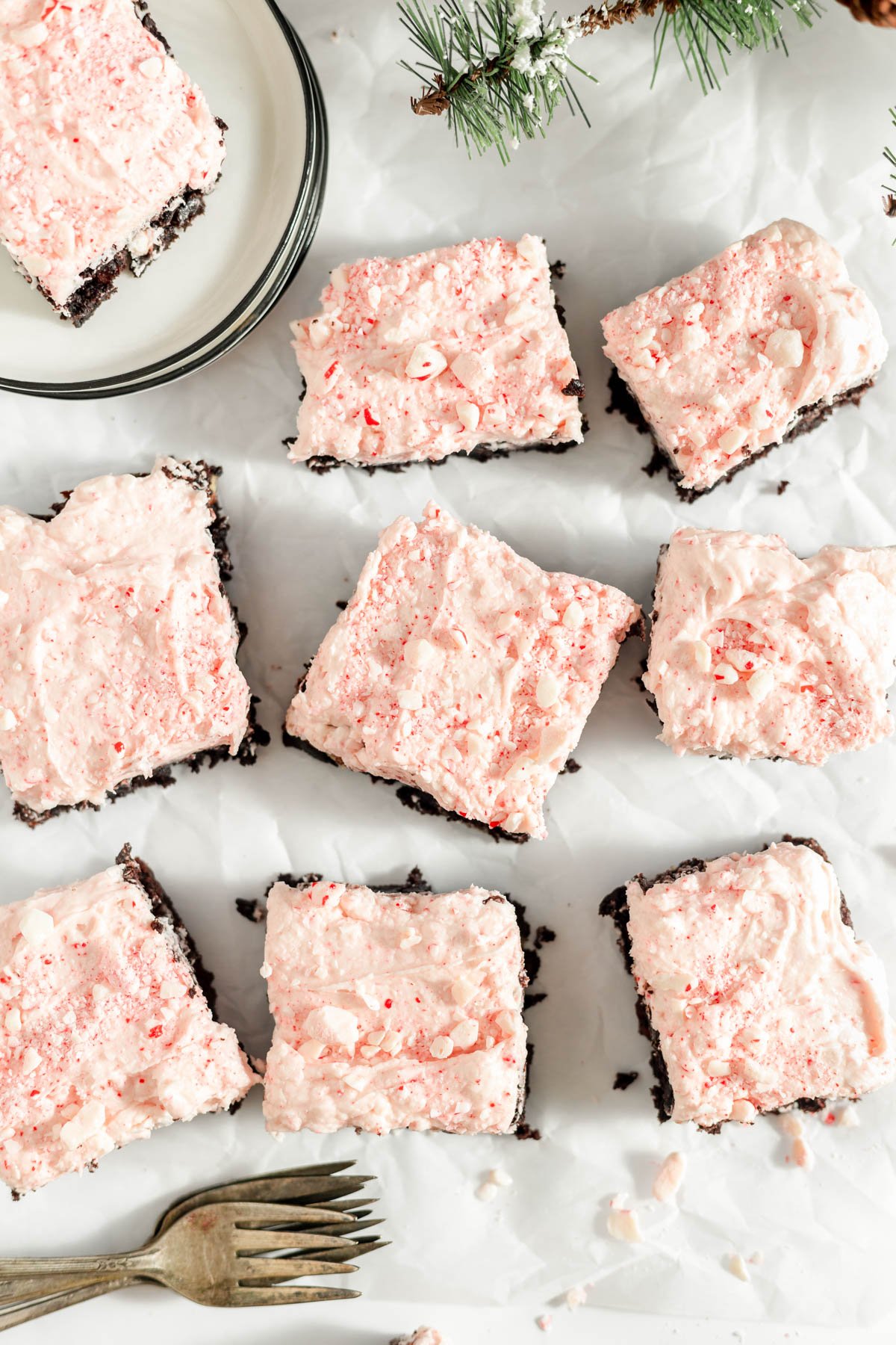 An image of brownies frosted with peppermint frosting with forks next to them.