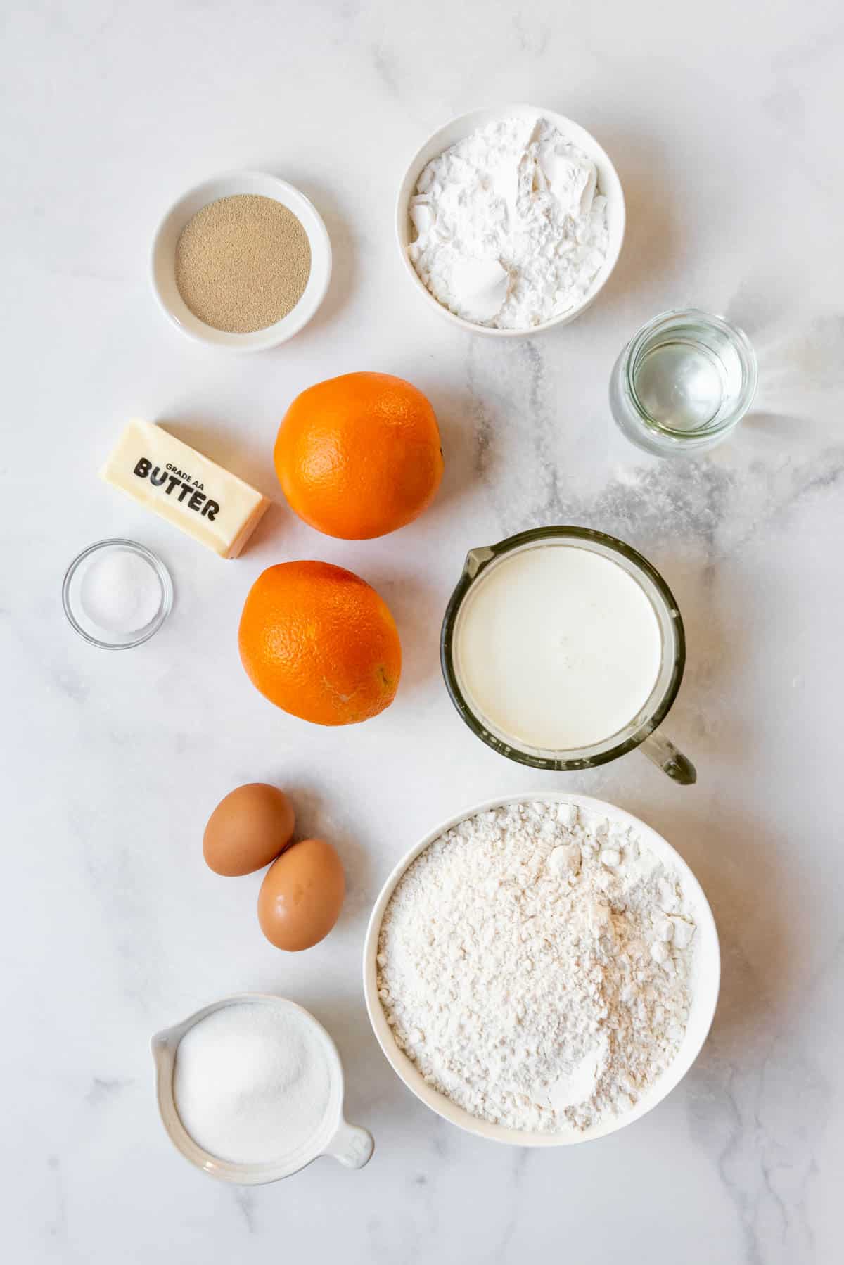 Ingredients for making homemade orange sweet rolls.