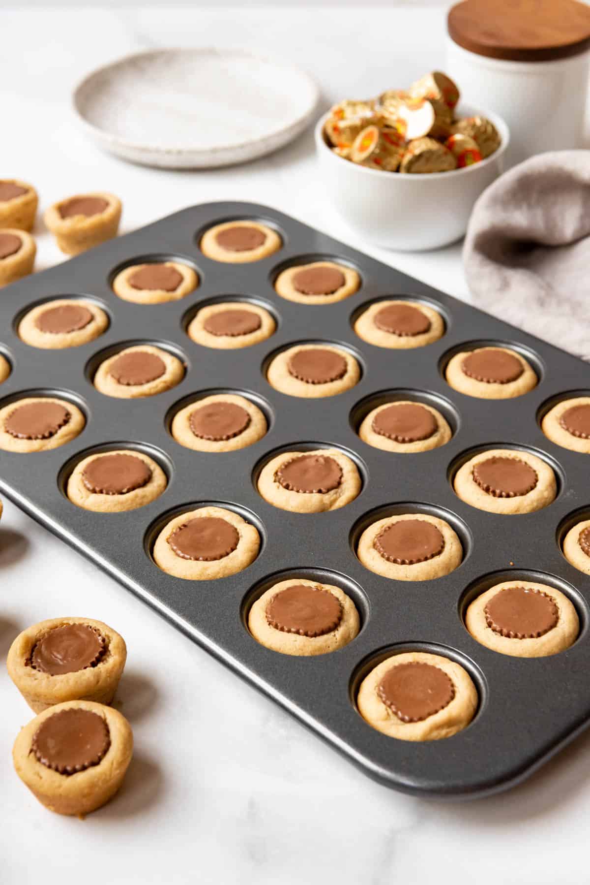 A tray of peanut butter cup cookies made with mini Reese's peanut butter cups.