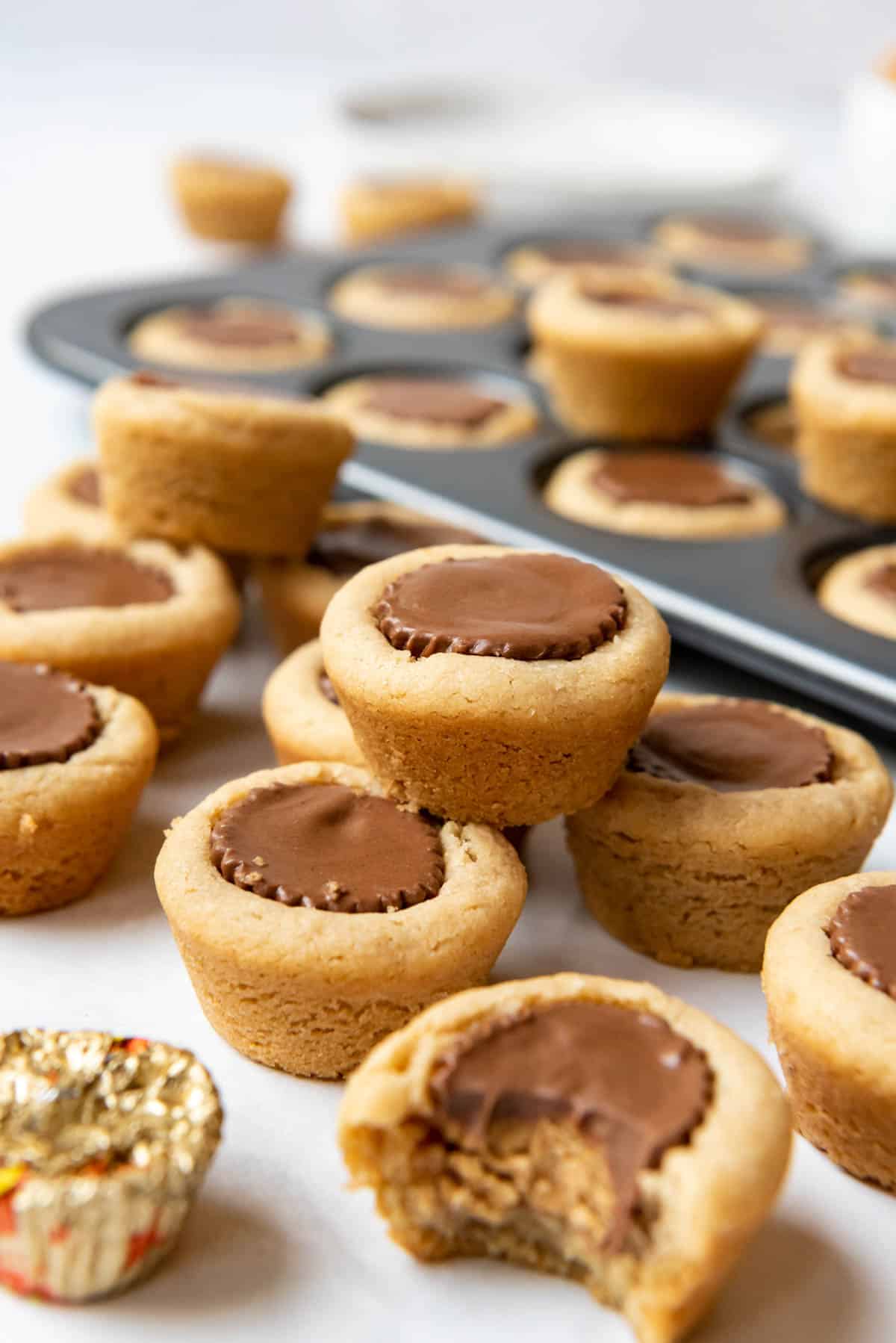 Stacked peanut butter cup cookies with a bite taken out of one of them.
