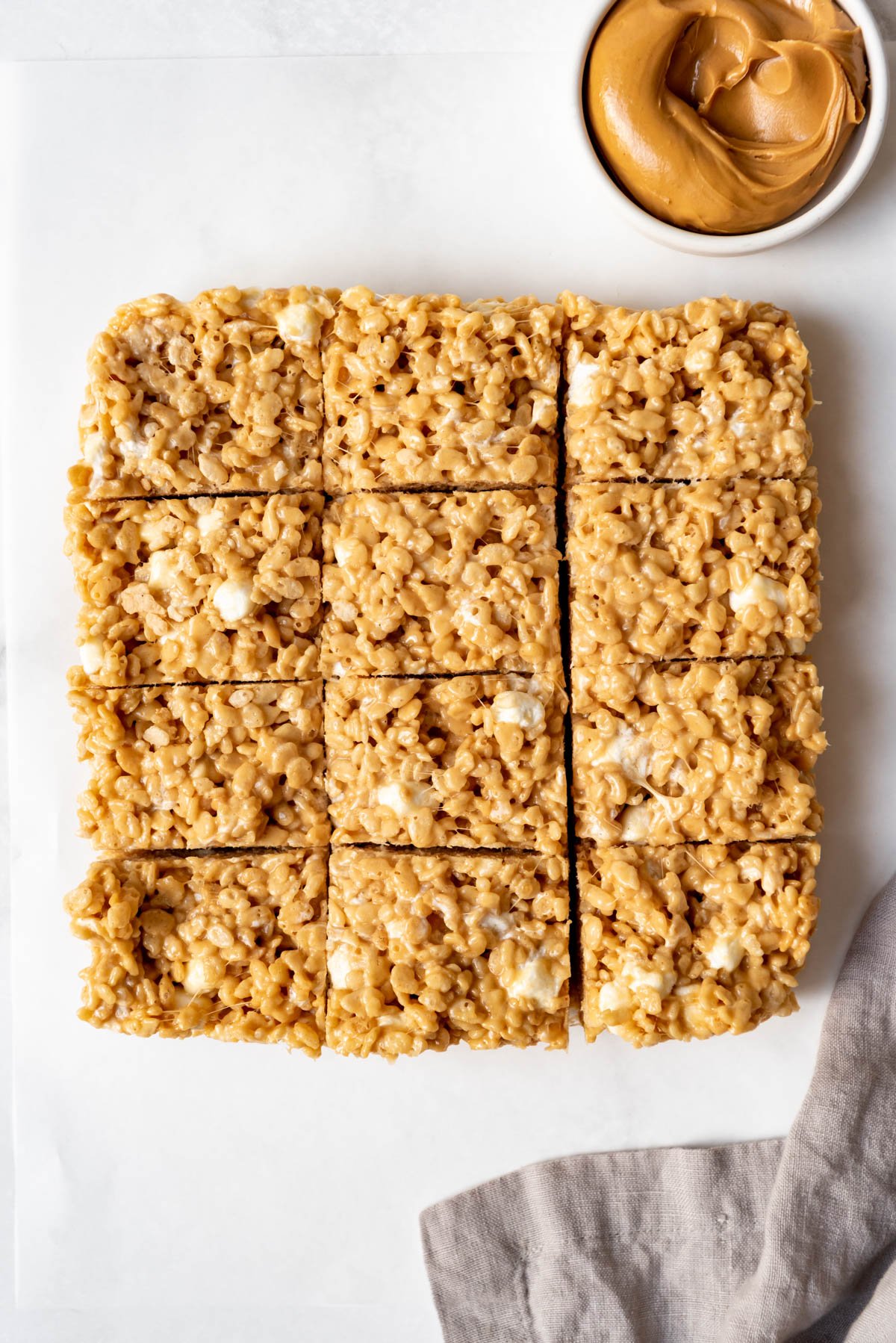 Top view of peanut butter rice krispie treats cut into squares. 