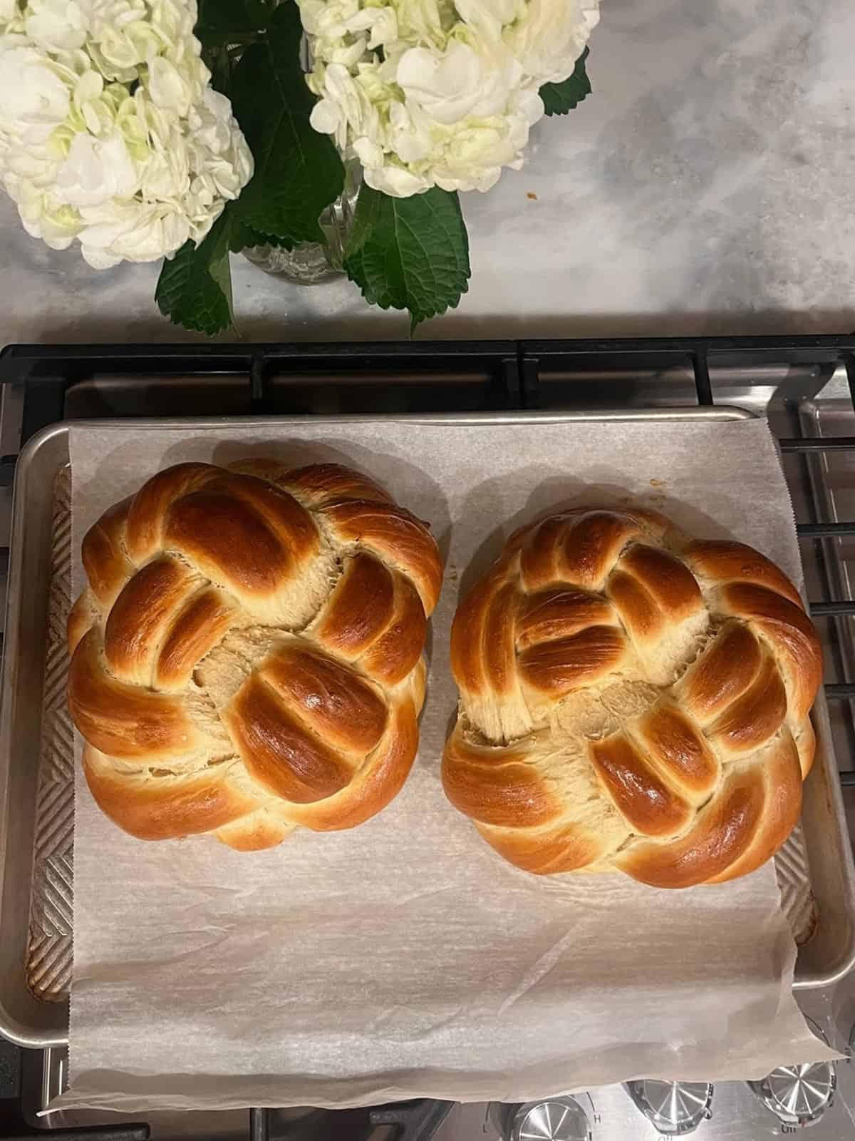 Two round braided loaves of challah bread.