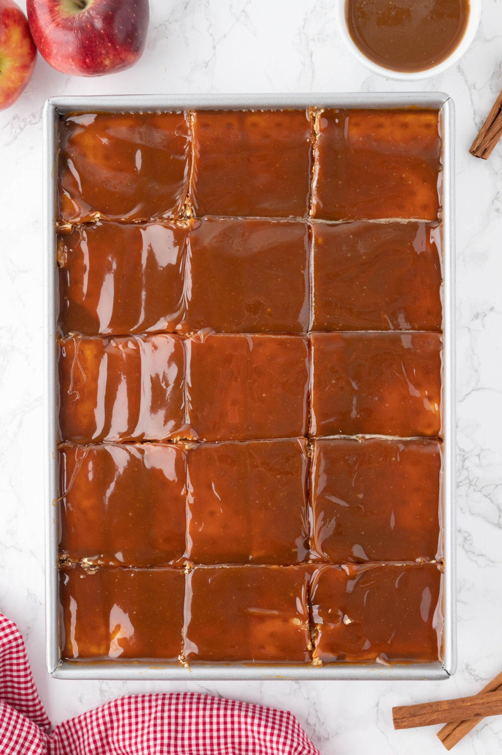 A caramel apple eclair cake that has been sliced into squares.