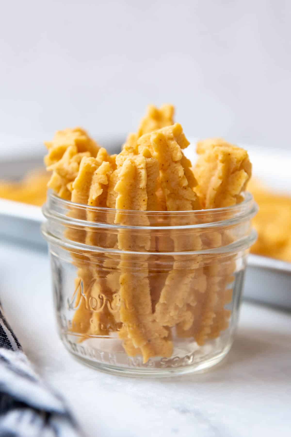 A glass mason jar filled with cheese straws.