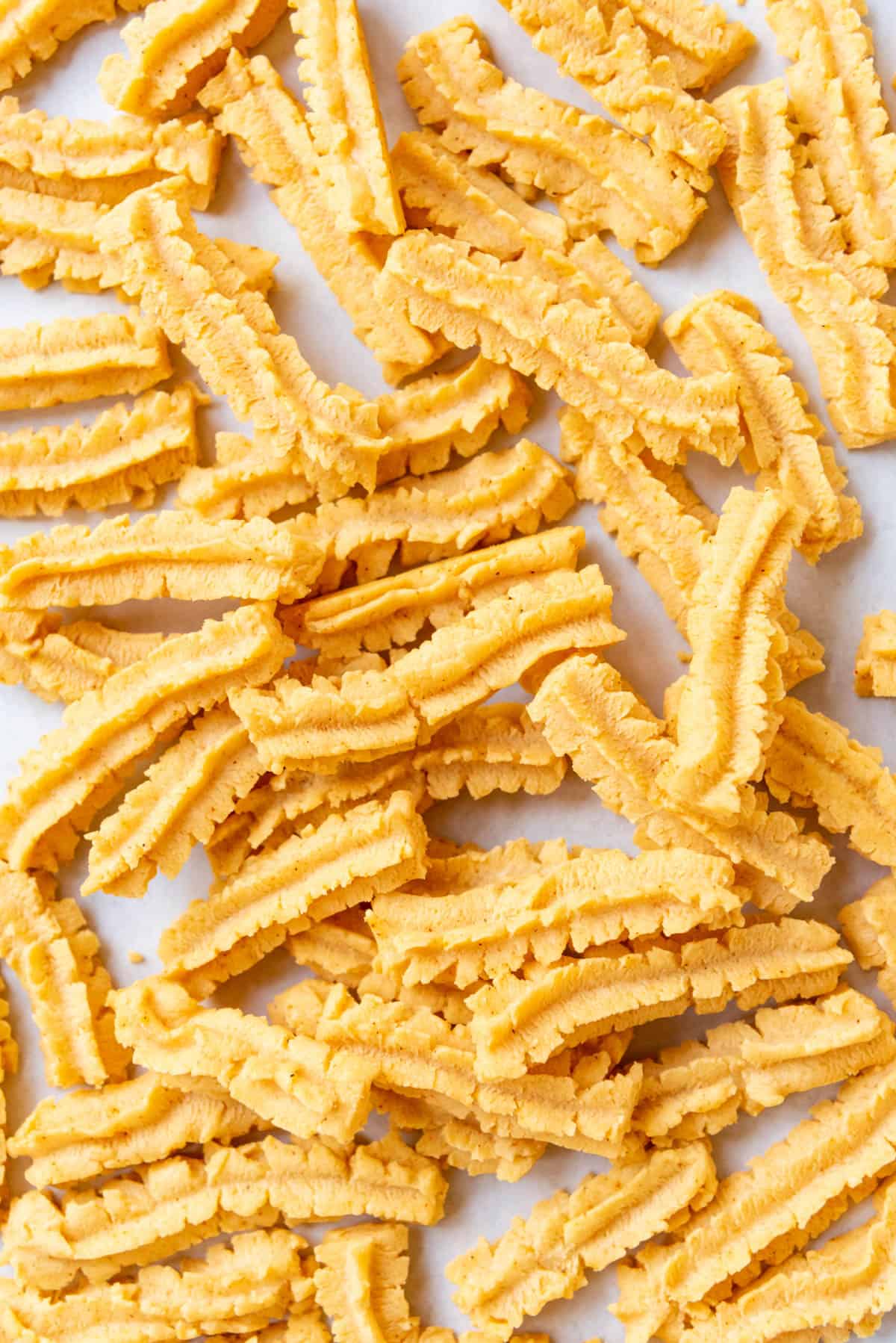 A close image of baked cheese straws.