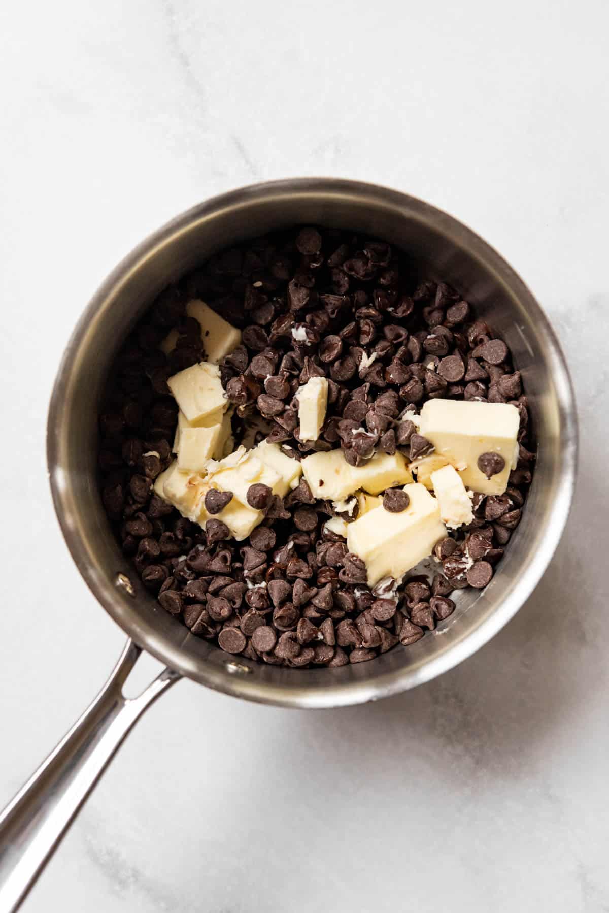 Butter and chocolate chips in a saucepan.