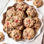 Fruitcake cookies piled on a round white plate.