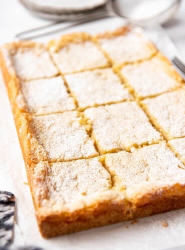 A gooey butter cake sliced into squares.