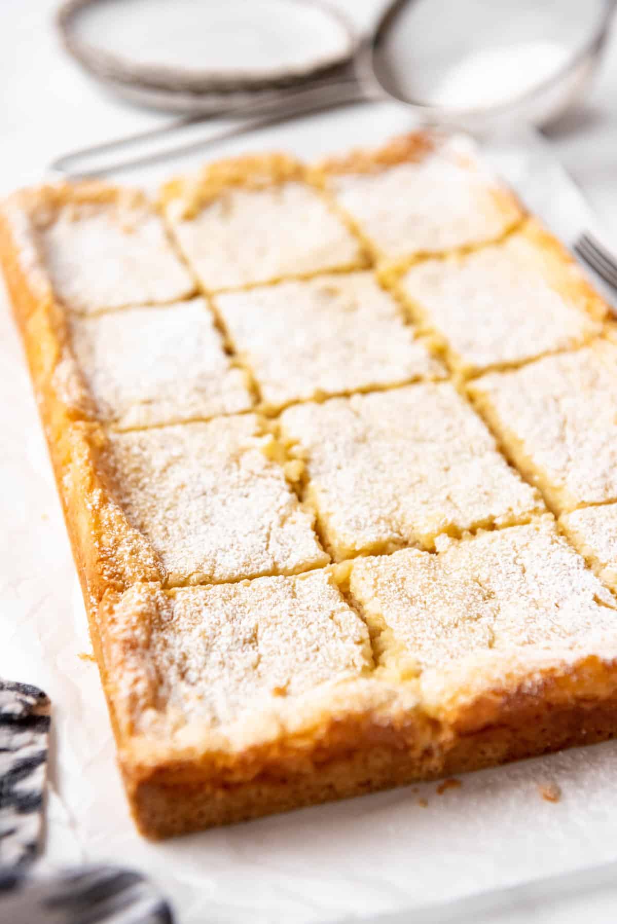 Close up of gooey butter cake sliced into squares.
