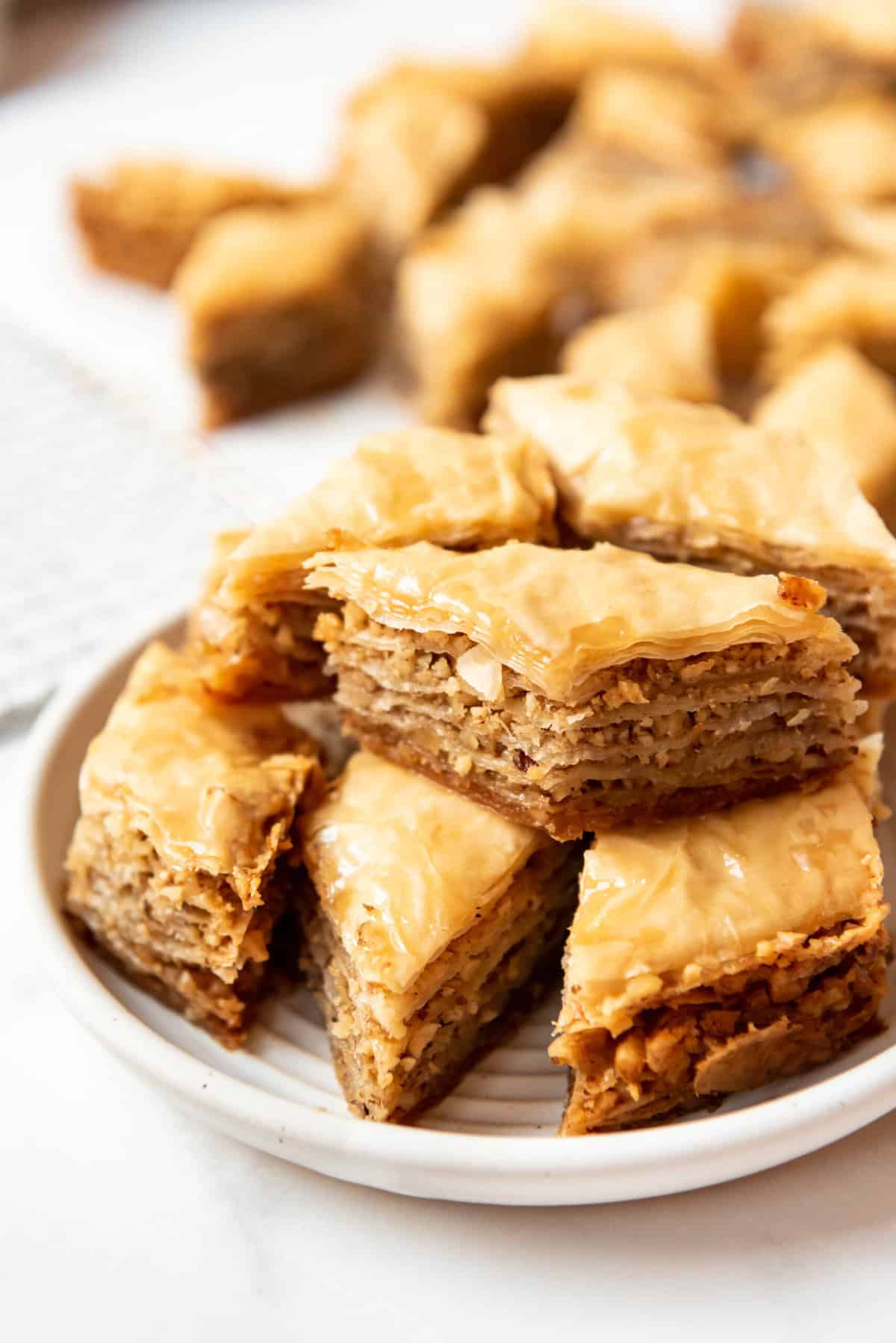 A plate of layered baklava with walnuts and honey syrup.