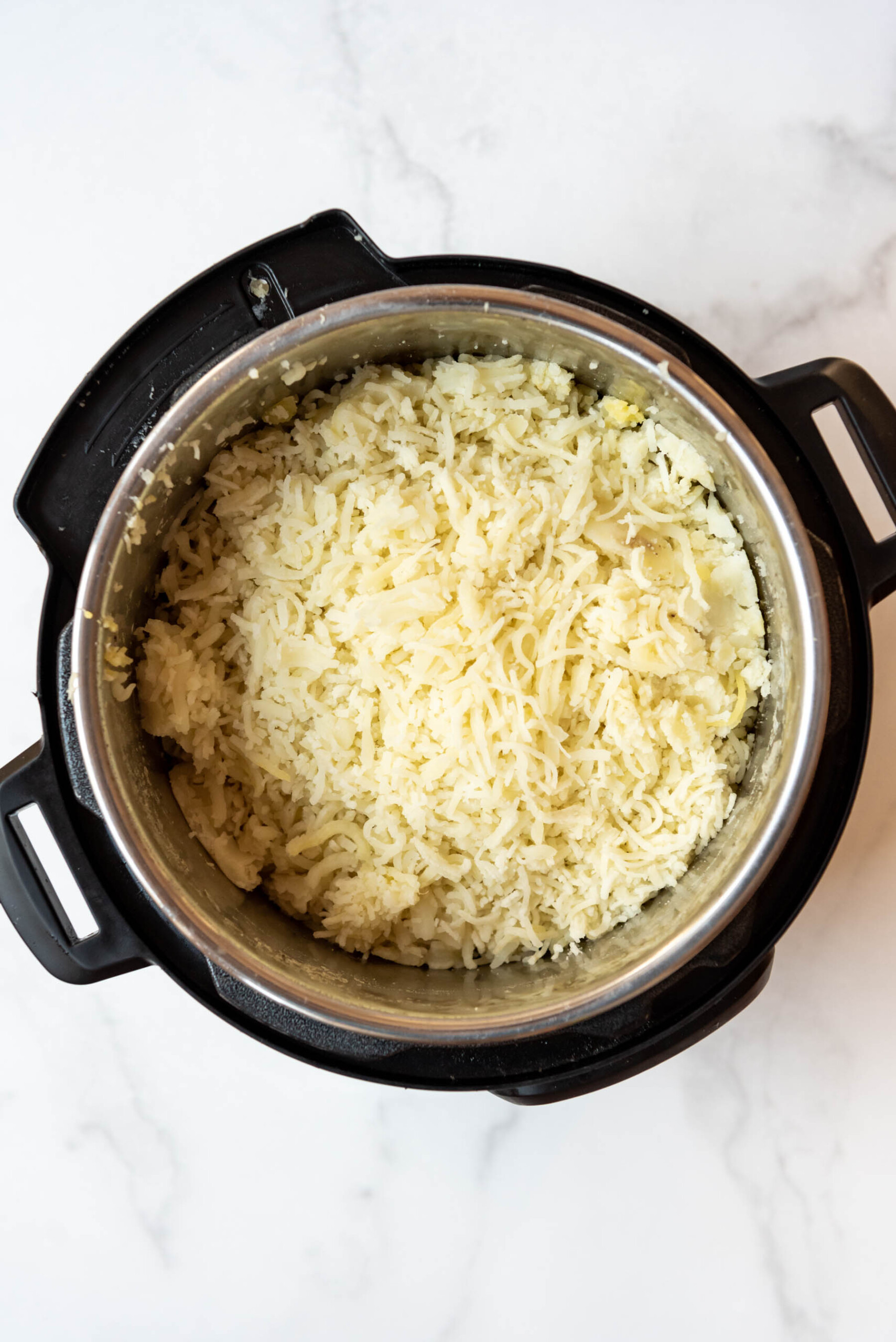 Top view of instant pot with freshly mashed potatoes inside. 