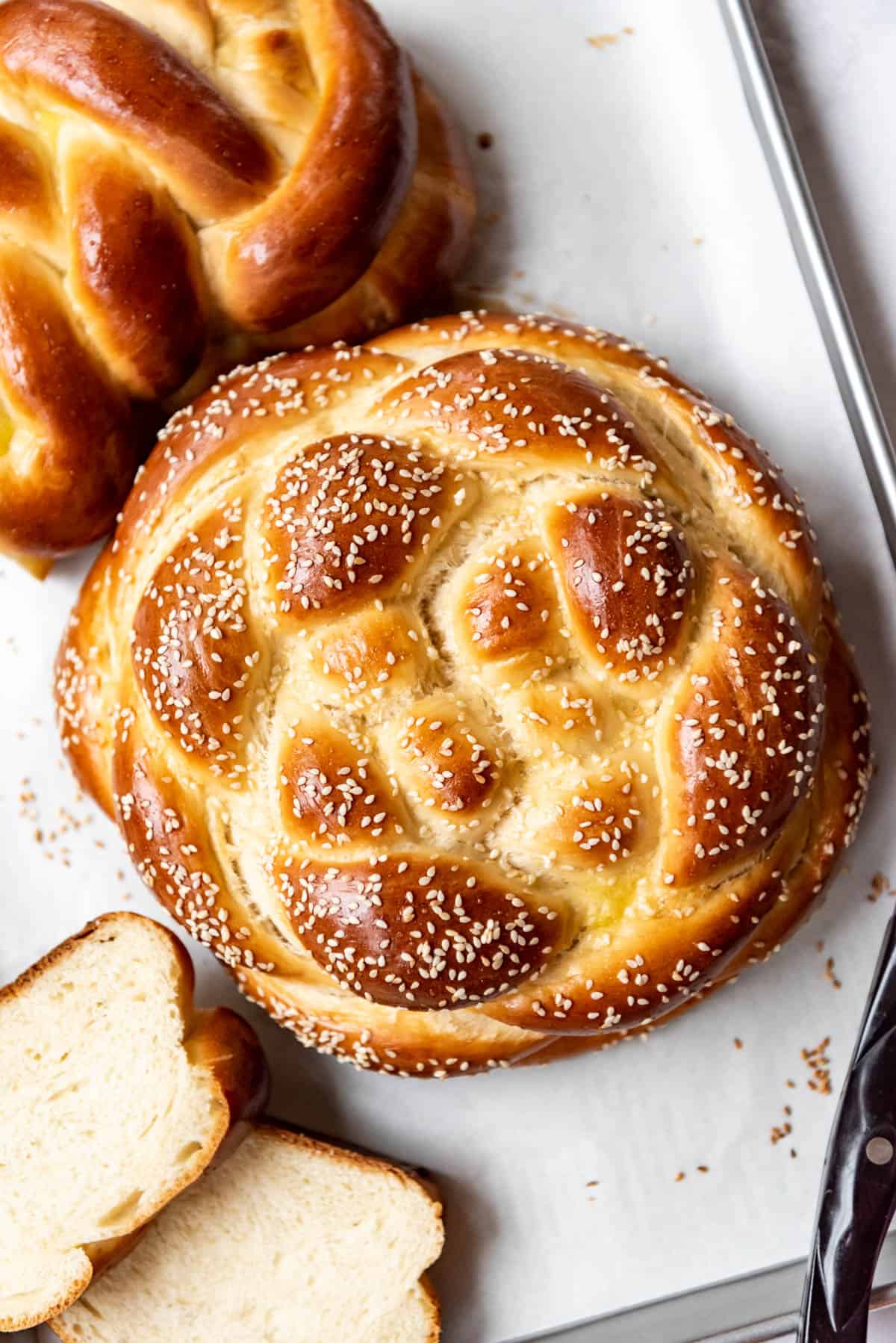 An overhead image of a braided round challah loaf.