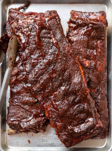 An image of three racks of St. Louis-Style Ribs on a baking sheet.