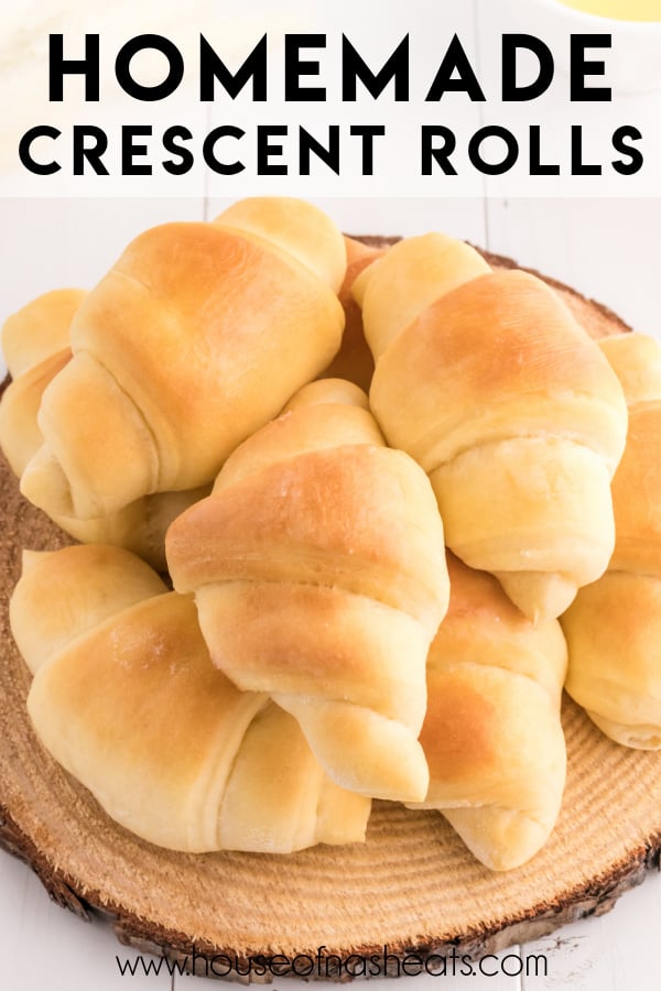 Soft homemade crescent rolls stacked on a wooden platter with text overlay.