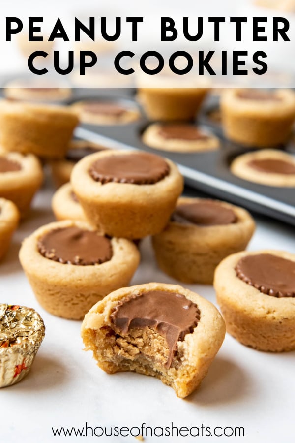 Peanut butter cup cookies with a bite taken out of one of them with text overlay.