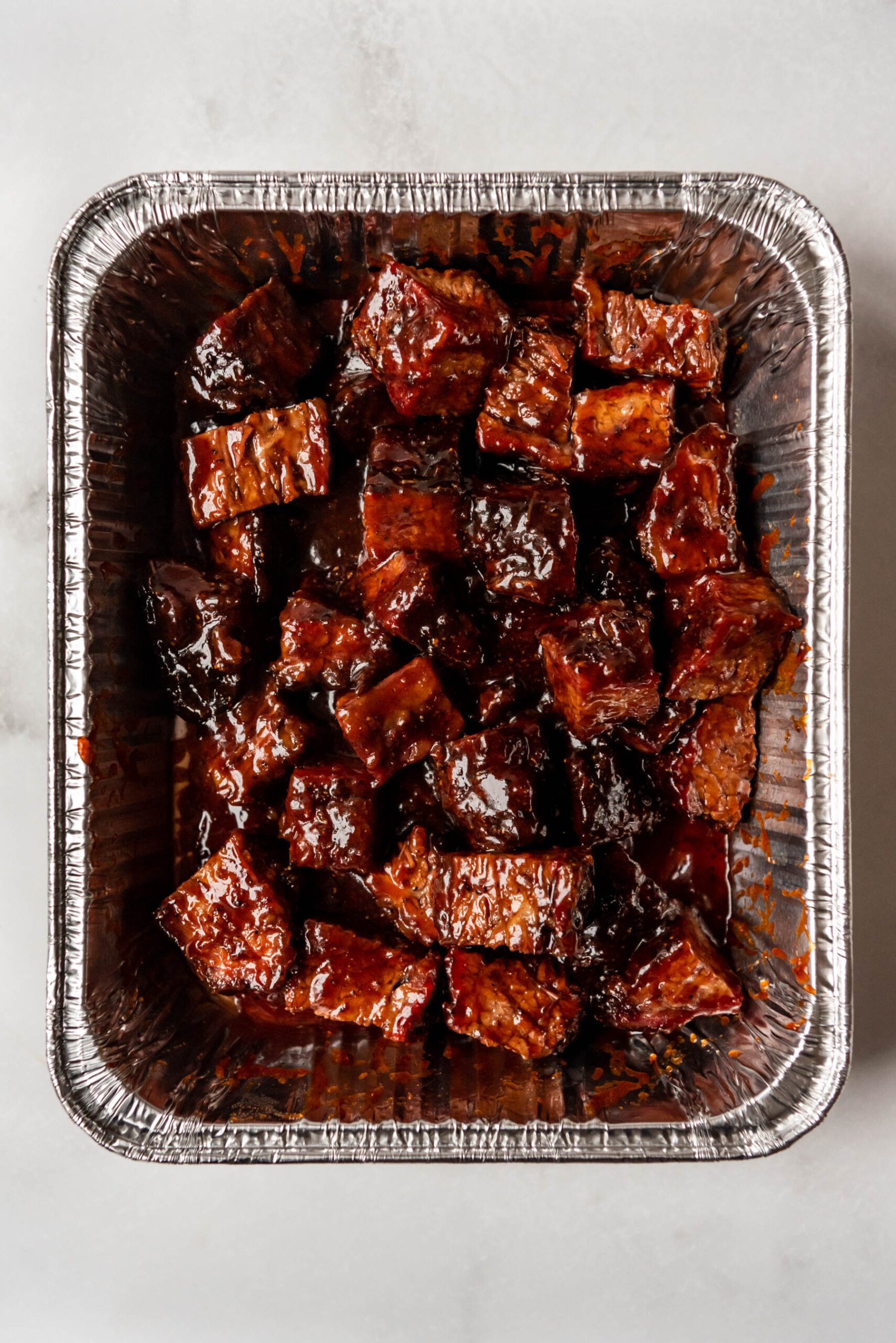 Partially finished brisket burnt ends after removing the foil covering them.