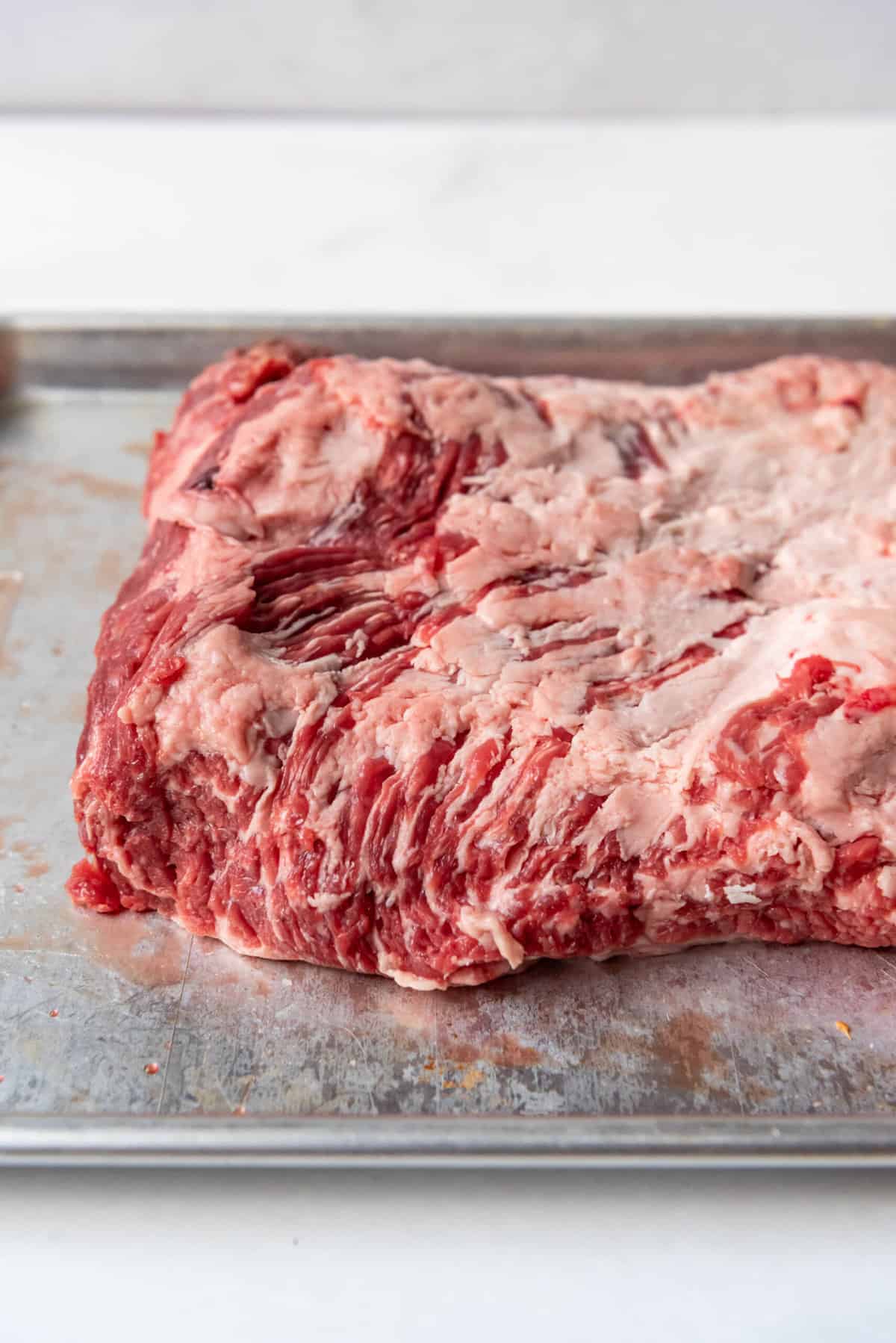 Beef brisket point meat on a baking sheet.