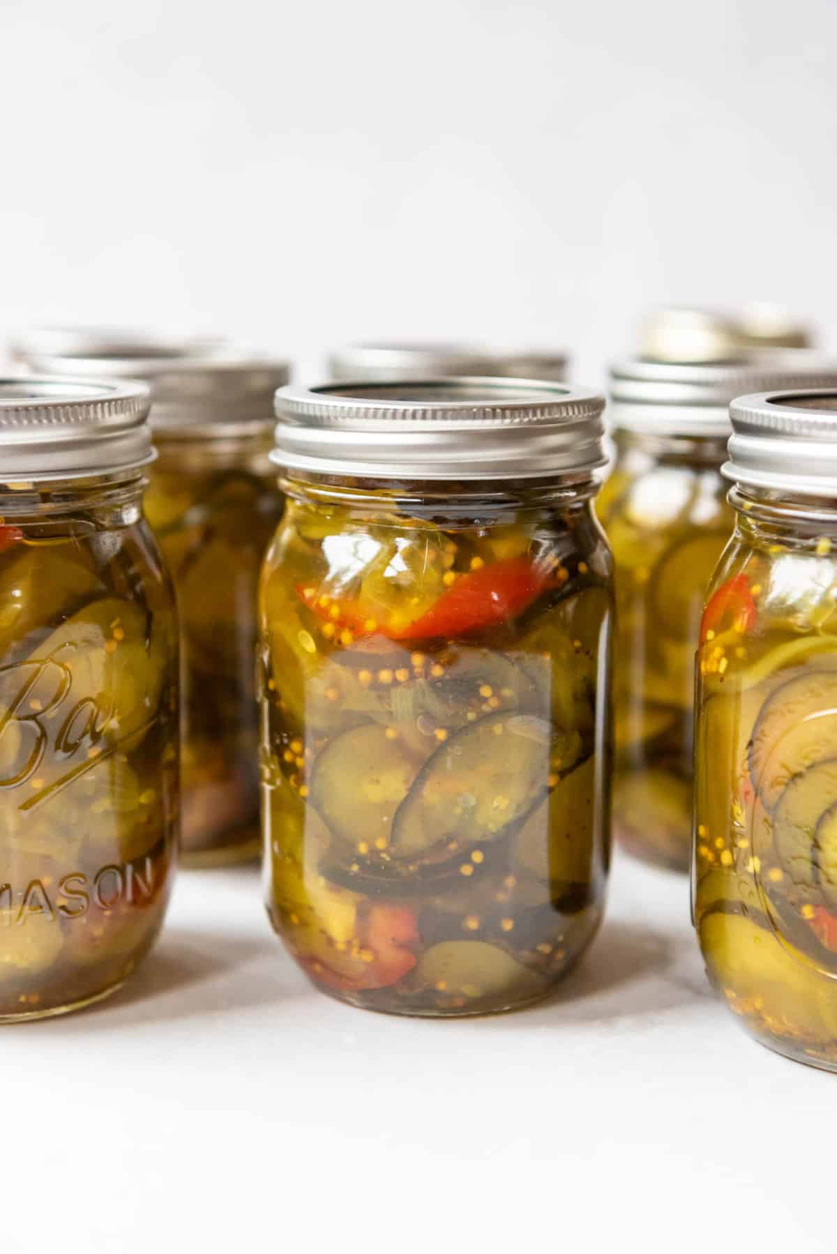 Jars of homemade bread & butter pickles in a row.