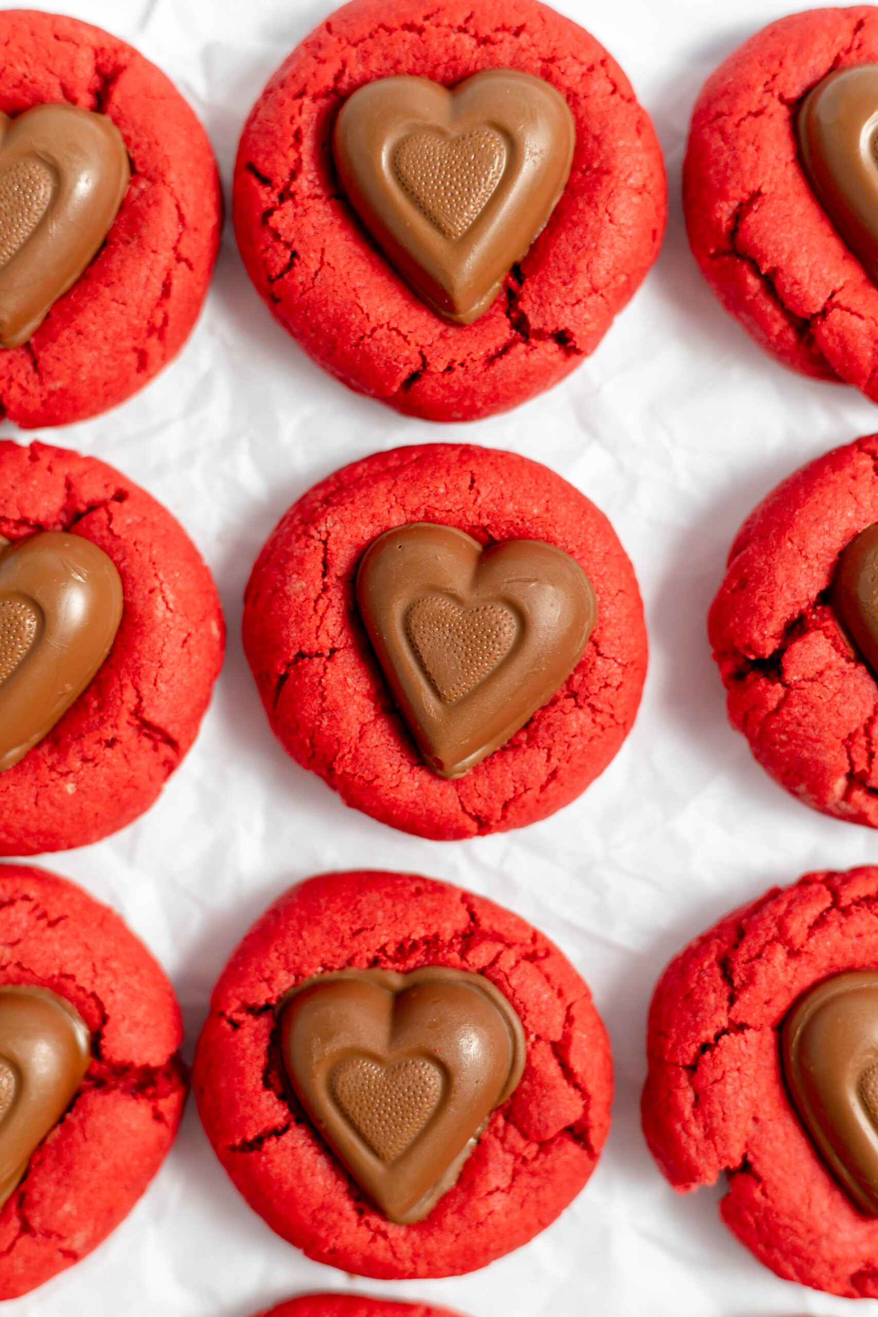 Red velvet cookies with chocolate hearts pressed into the tops.