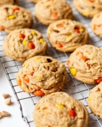 Reese's Pieces cookies on a wire cooling rack.