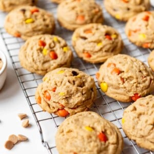 Reese's Pieces cookies on a wire cooling rack.