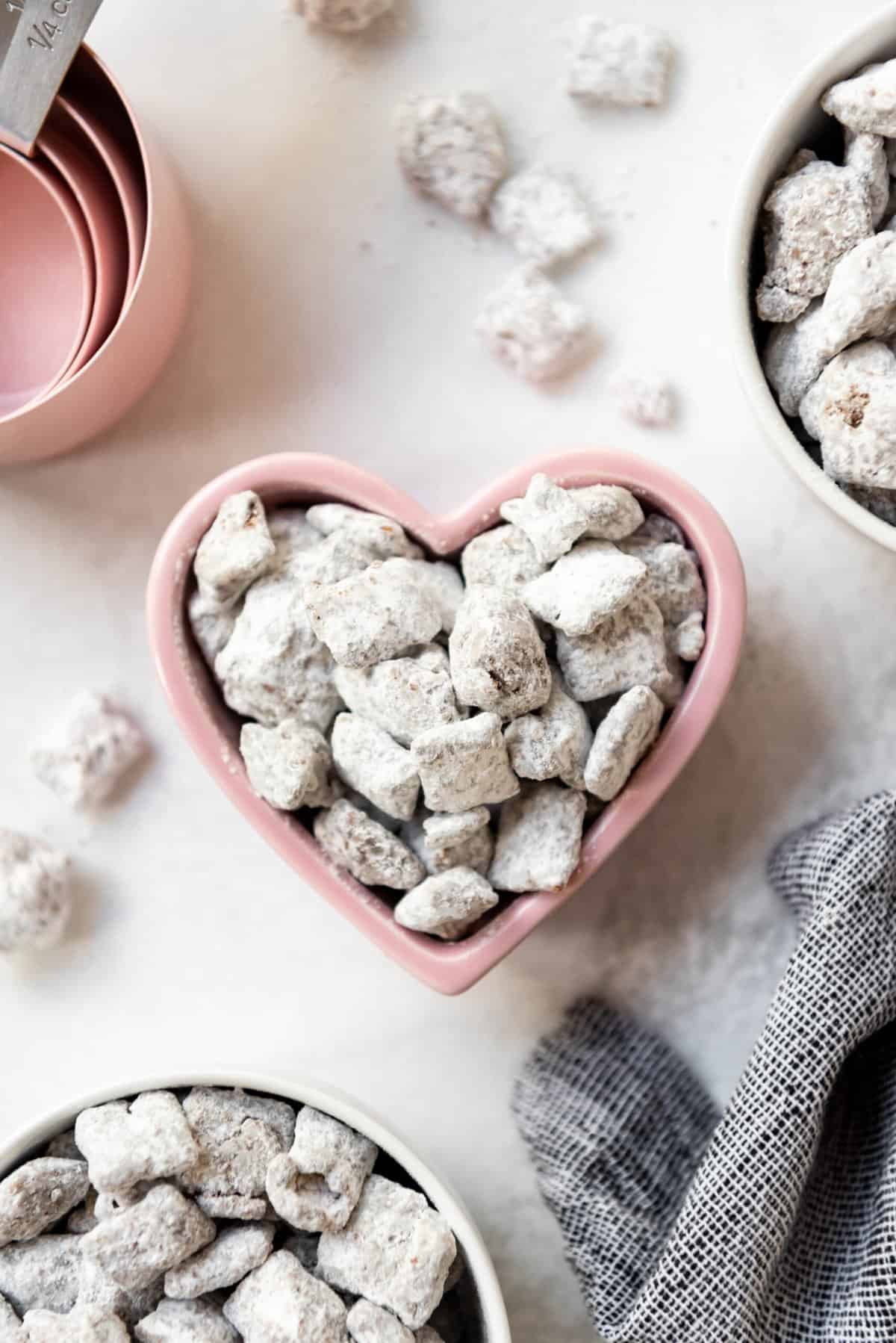 An image of muddy buddies in a heart shaped bowl.