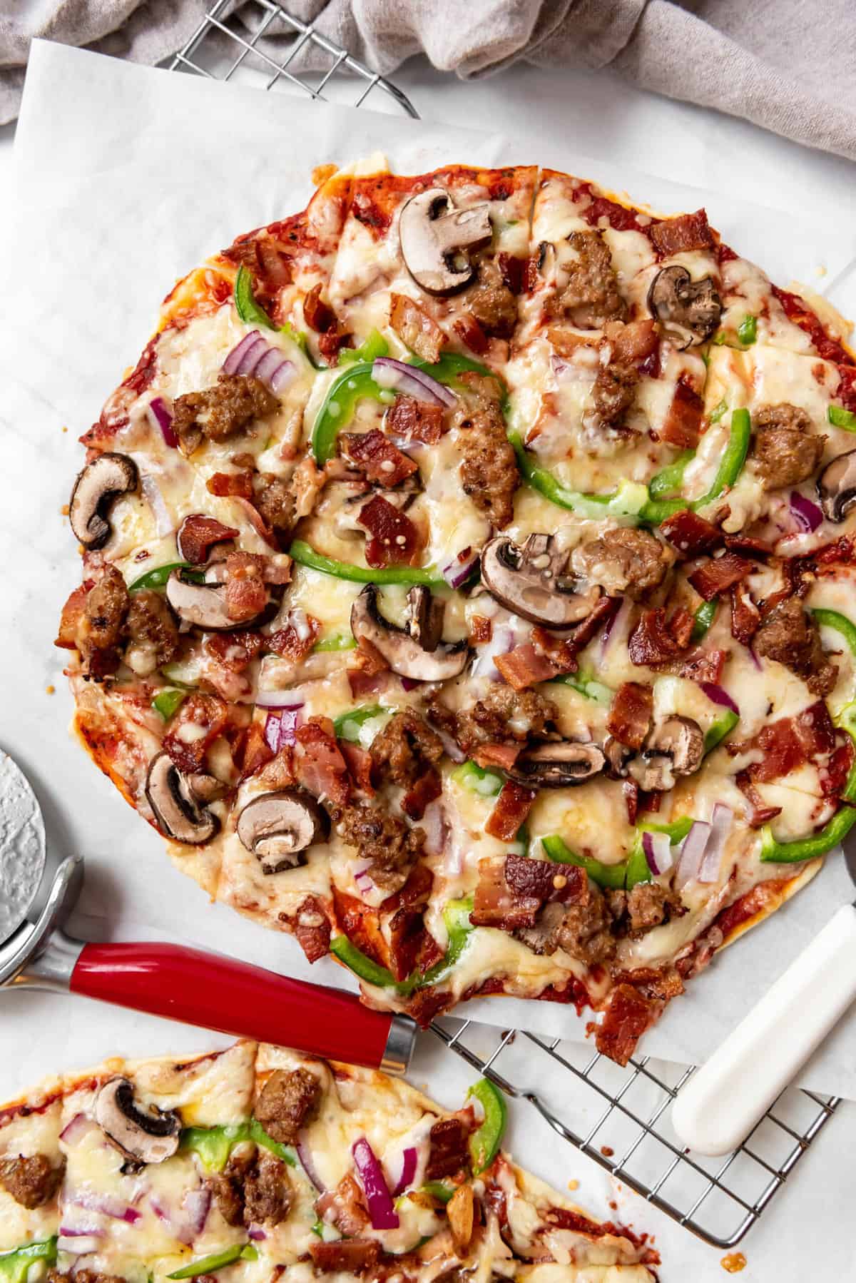 An overhead image of a square cut St. Louis style Imo's copycat deluxe pizza.